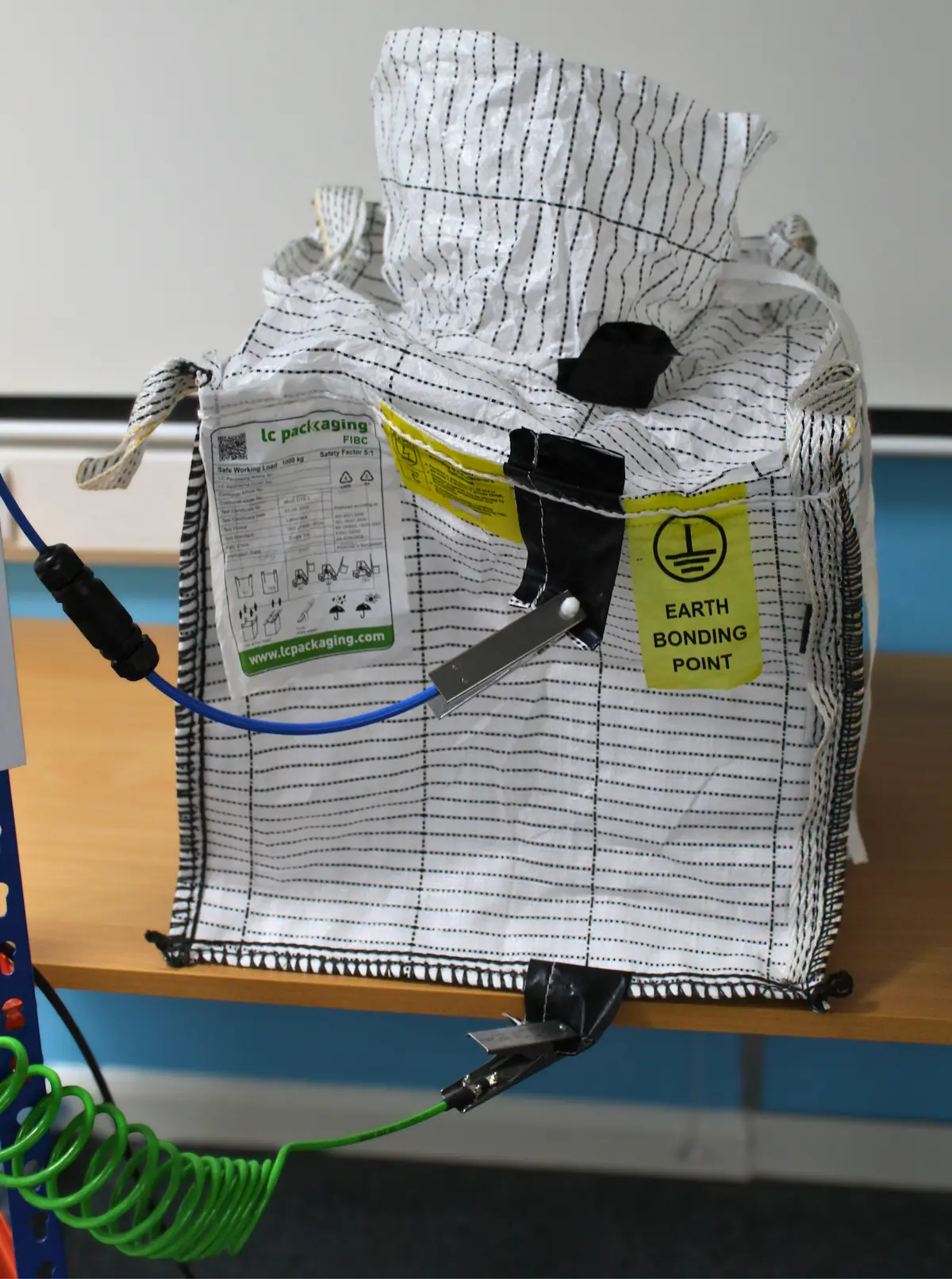 Type C FIBC connected to a verified grounding point using two grounding clamps